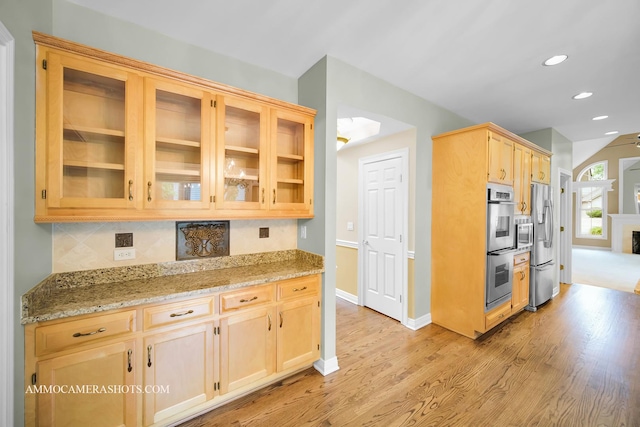 792 Black Walnut Dr, Sugar Grove, IL 60554 - kitchen featuring light brown cabinets, light wood finished floors, stainless steel appliances, decorative backsplash, and glass insert cabinets