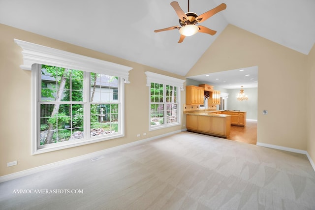 792 Black Walnut Dr, Sugar Grove, IL 60554 - unfurnished living room with high vaulted ceiling, ceiling fan, light carpet, and a chandelier