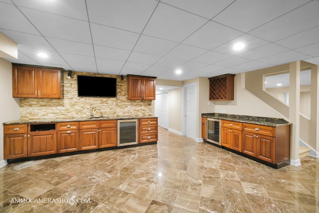 792 Black Walnut Dr, Sugar Grove, IL 60554 - kitchen featuring beverage cooler, dark stone countertops, brown cabinets, recessed lighting, and a paneled ceiling