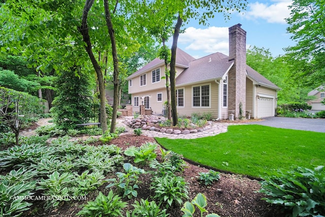 792 Black Walnut Dr, Sugar Grove, IL 60554 - view of front of house featuring a front lawn, a chimney, asphalt driveway, and an attached garage