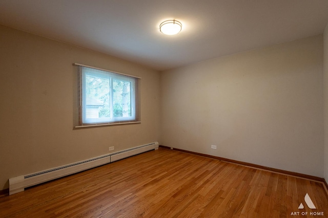 14940 Wilco Dr, Homer Glen, IL 60491 - unfurnished room with a baseboard heating unit, light wood-style flooring, and baseboards