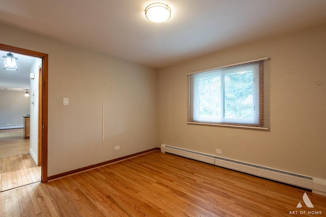 14940 Wilco Dr, Homer Glen, IL 60491 - spare room featuring a baseboard radiator, light wood-style flooring, and baseboards