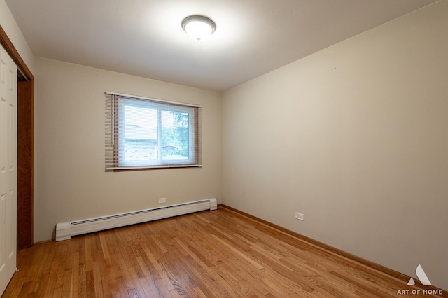 14940 Wilco Dr, Homer Glen, IL 60491 - unfurnished bedroom with a baseboard radiator, light wood-style floors, baseboards, and a closet