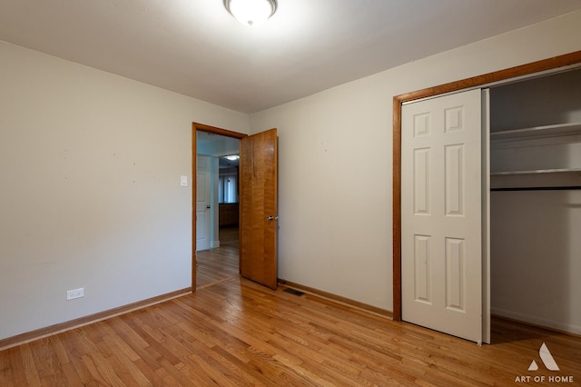 14940 Wilco Dr, Homer Glen, IL 60491 - unfurnished bedroom with baseboards, a closet, and light wood finished floors