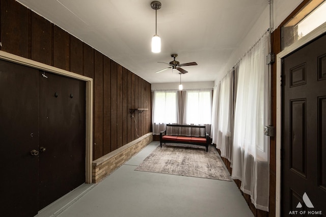 14940 Wilco Dr, Homer Glen, IL 60491 - bedroom featuring finished concrete flooring, wood walls, and ceiling fan