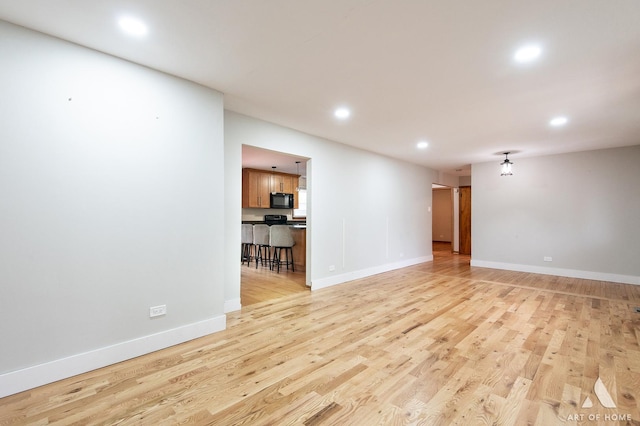 14940 Wilco Dr, Homer Glen, IL 60491 - unfurnished living room with recessed lighting, light wood finished floors, and baseboards
