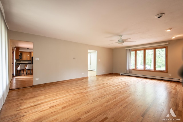 14940 Wilco Dr, Homer Glen, IL 60491 - spare room with ceiling fan, light wood-style flooring, a baseboard radiator, and a baseboard heating unit