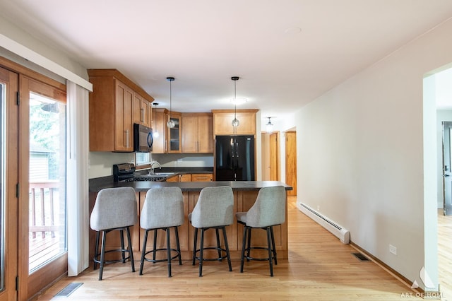 14940 Wilco Dr, Homer Glen, IL 60491 - kitchen featuring black appliances, baseboard heating, a peninsula, dark countertops, and a sink