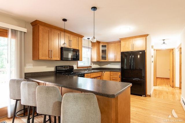 14940 Wilco Dr, Homer Glen, IL 60491 - kitchen featuring black appliances, dark countertops, a peninsula, and plenty of natural light