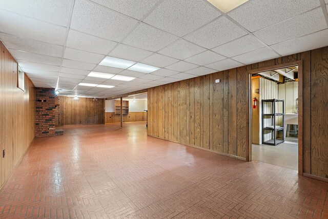 9017 S 50th Ave, Oak Lawn, IL 60453 - finished below grade area with wooden walls, a paneled ceiling, brick patterned flooring, and baseboards