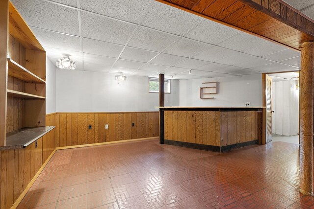 9017 S 50th Ave, Oak Lawn, IL 60453 - indoor dry bar featuring a paneled ceiling, brick patterned flooring, a wainscoted wall, wood walls, and baseboards