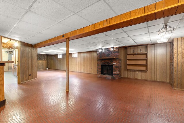 9017 S 50th Ave, Oak Lawn, IL 60453 - finished below grade area featuring a paneled ceiling, brick patterned flooring, wood walls, and a brick fireplace