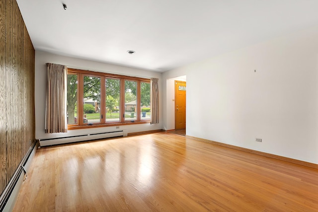 9017 S 50th Ave, Oak Lawn, IL 60453 - unfurnished room with a baseboard radiator, light wood finished floors, and baseboards