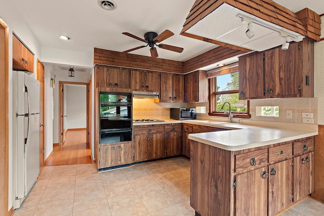 9017 S 50th Ave, Oak Lawn, IL 60453 - kitchen with black oven, freestanding refrigerator, a warming drawer, a peninsula, and a ceiling fan