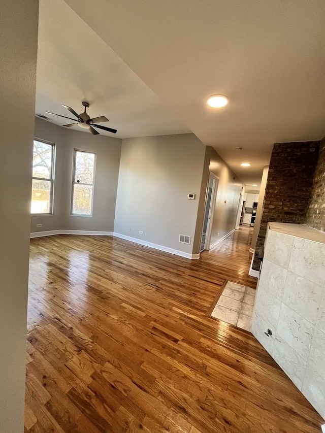501 W 60th Pl Unit 3, Chicago, IL 60621 - empty room with wood finished floors, baseboards, and a ceiling fan