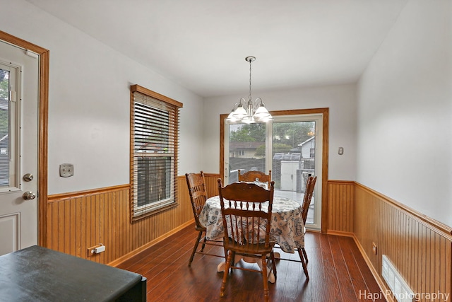1428 Juneway Ter, Round Lake Beach, IL 60073 - dining area with wainscoting, a chandelier, healthy amount of natural light, dark wood-style flooring, and wood walls