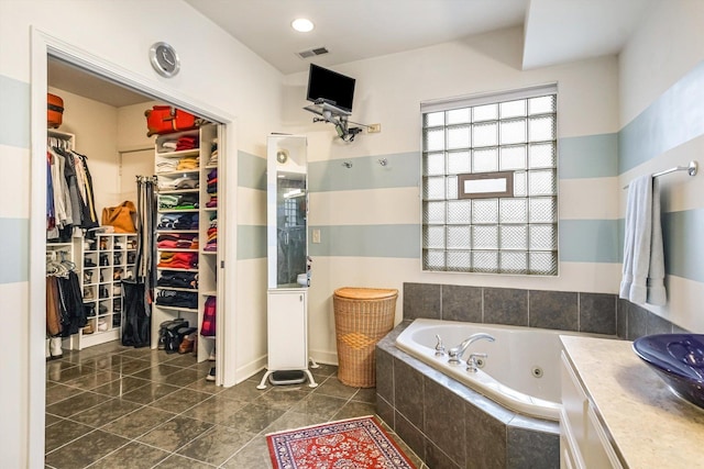 26 E 14th Pl, Chicago, IL 60605 - bathroom with a whirlpool tub, vanity, a spacious closet, and tile patterned floors