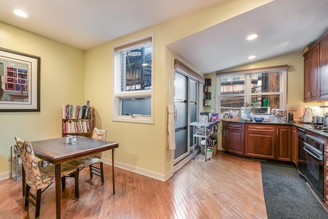 26 E 14th Pl, Chicago, IL 60605 - kitchen featuring black oven, light wood-style floors, baseboards, dark countertops, and recessed lighting