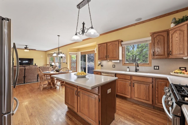 730 N Hundley St, Hoffman Estates, IL 60169 - kitchen with stainless steel appliances, a sink, light countertops, a center island, and hanging light fixtures
