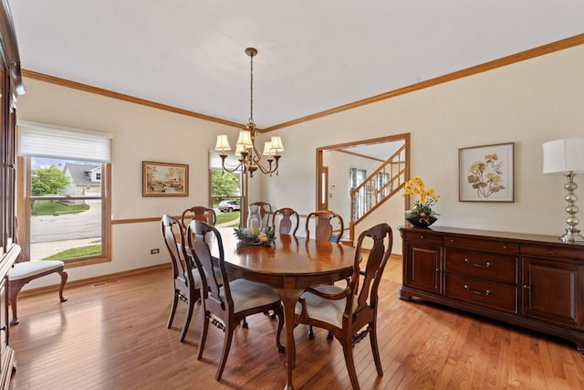 730 N Hundley St, Hoffman Estates, IL 60169 - dining space featuring a chandelier, light wood-type flooring, healthy amount of natural light, ornamental molding, and baseboards