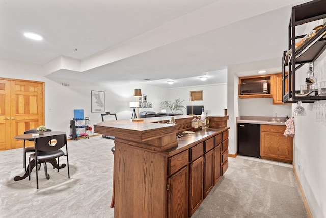 730 N Hundley St, Hoffman Estates, IL 60169 - kitchen featuring light colored carpet, black appliances, open floor plan, baseboards, and a sink