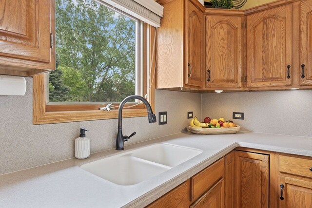 730 N Hundley St, Hoffman Estates, IL 60169 - kitchen with a sink, light countertops, and brown cabinetry