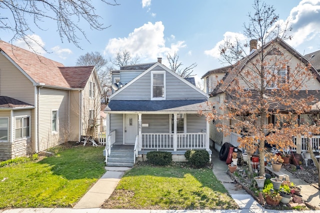 1661 Euclid Ave, Chicago Heights, IL 60411 - bungalow-style home featuring a porch, a front lawn, and roof with shingles