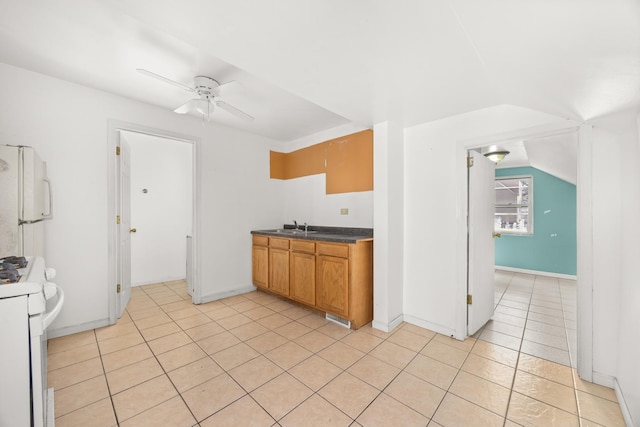1661 Euclid Ave, Chicago Heights, IL 60411 - kitchen with white appliances, ceiling fan, a sink, light tile patterned floors, and dark countertops