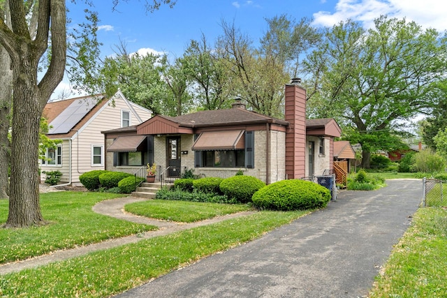 16 W Monroe St, Villa Park, IL 60181 - view of front of house with a chimney, brick siding, and a front yard