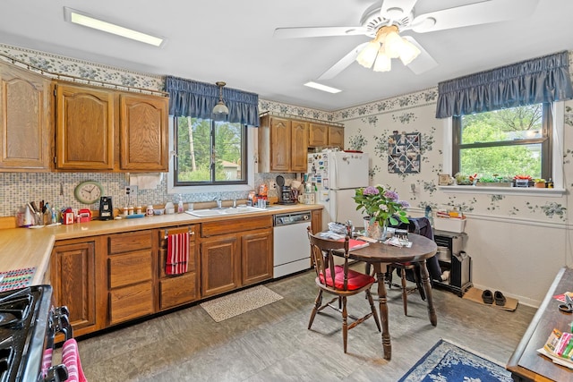 16 W Monroe St, Villa Park, IL 60181 - kitchen featuring white appliances, a sink, light countertops, brown cabinetry, and a ceiling fan