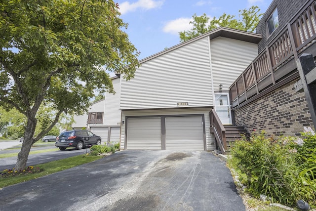 3S261 Briarwood Dr, Warrenville, IL 60555 - view of side of home featuring an attached garage and asphalt driveway