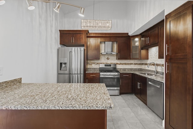 3S261 Briarwood Dr, Warrenville, IL 60555 - kitchen featuring stainless steel appliances, wall chimney exhaust hood, a sink, backsplash, and a peninsula