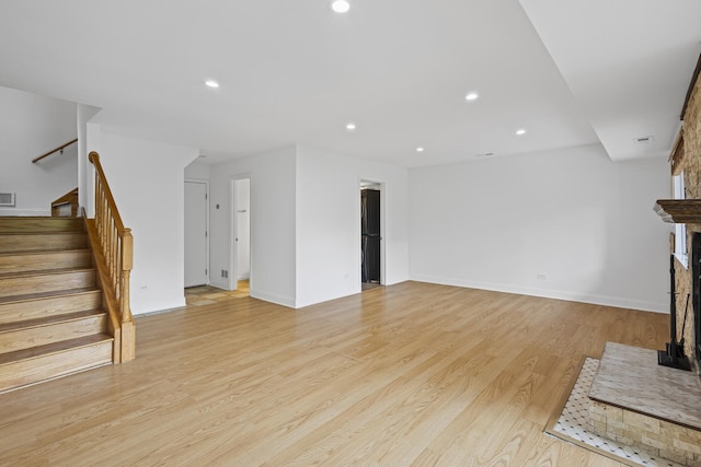 3S261 Briarwood Dr, Warrenville, IL 60555 - unfurnished living room featuring stairs, recessed lighting, light wood finished floors, baseboards, and a fireplace