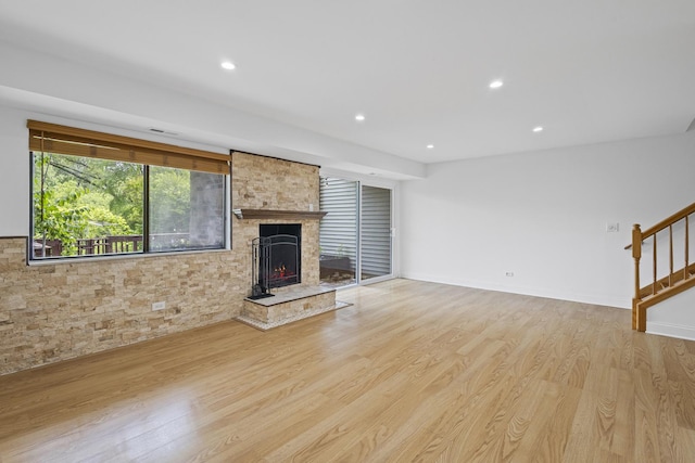 3S261 Briarwood Dr, Warrenville, IL 60555 - unfurnished living room featuring light wood-style flooring, recessed lighting, stairs, and a fireplace