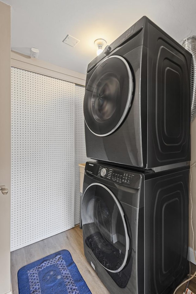 3S261 Briarwood Dr, Warrenville, IL 60555 - washroom with stacked washer / drying machine and wood finished floors