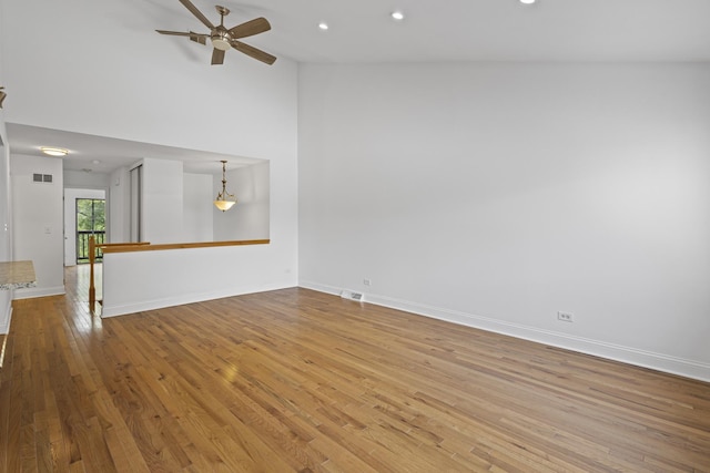 3S261 Briarwood Dr, Warrenville, IL 60555 - unfurnished living room featuring wood finished floors, ceiling fan, recessed lighting, high vaulted ceiling, and baseboards