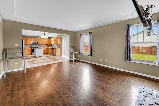 4311 187th St, Country Club Hills, IL 60478 - unfurnished living room featuring baseboards and light wood-style flooring