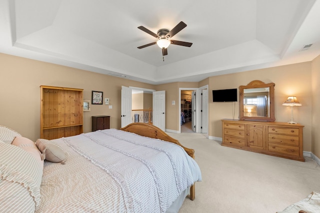10423 Capistrano Ln, Orland Park, IL 60467 - bedroom featuring a raised ceiling, light carpet, a walk in closet, ceiling fan, and a closet