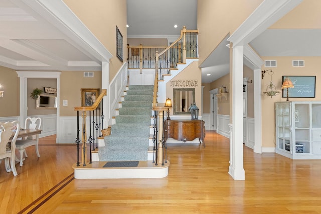 10423 Capistrano Ln, Orland Park, IL 60467 - foyer entrance featuring stairs, wood finished floors, a decorative wall, wainscoting, and decorative columns