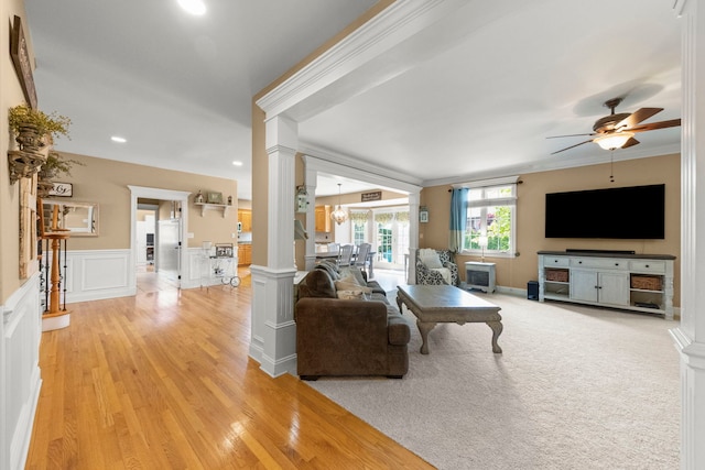 10423 Capistrano Ln, Orland Park, IL 60467 - living area with ornate columns, ceiling fan, ornamental molding, light wood-style floors, and a wainscoted wall