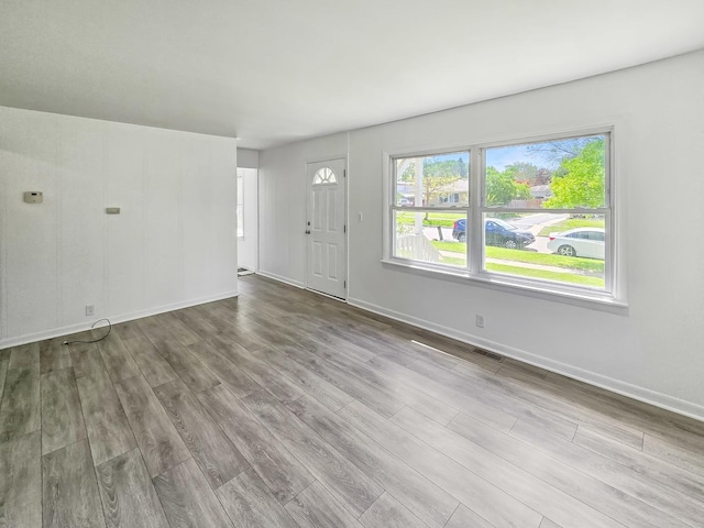 511 E Stimmel St, West Chicago, IL 60185 - unfurnished living room featuring wood finished floors and baseboards