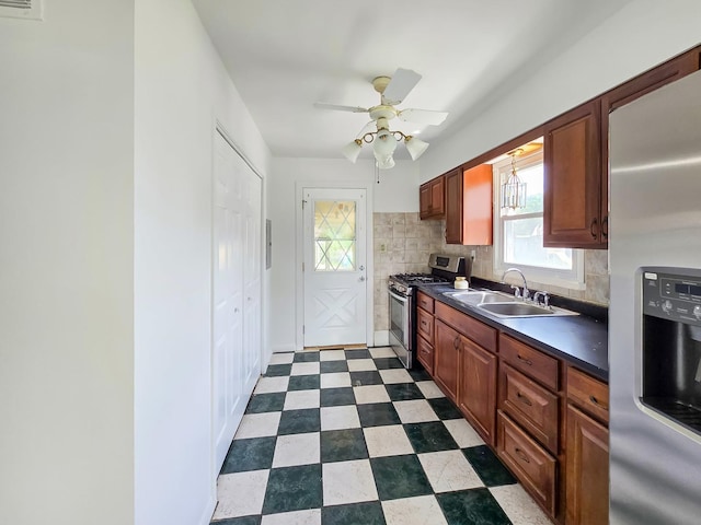 511 E Stimmel St, West Chicago, IL 60185 - kitchen featuring stainless steel appliances, a sink, dark countertops, tasteful backsplash, and dark flooring