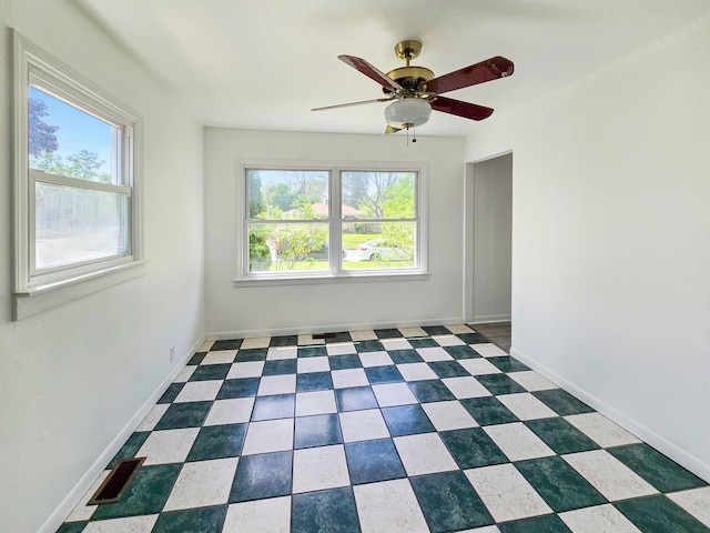 511 E Stimmel St, West Chicago, IL 60185 - unfurnished room with plenty of natural light, a ceiling fan, and baseboards