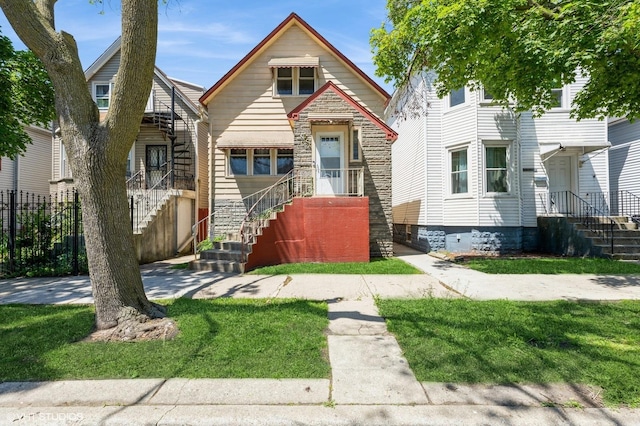 10624 S Ave H Rd, Chicago, IL 60617 - view of front of property with stone siding and a front yard