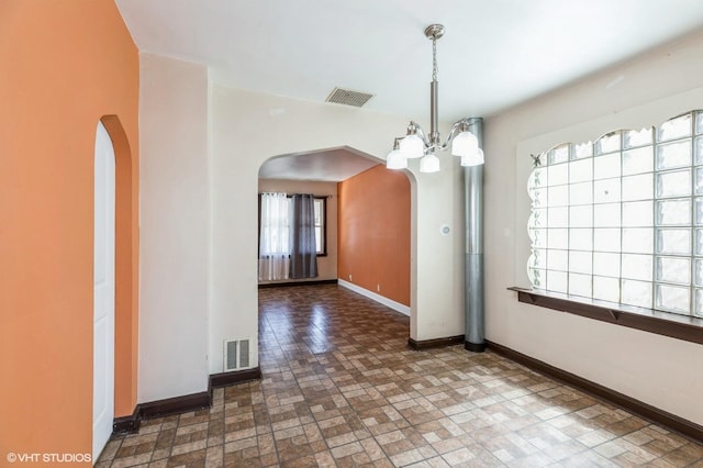 10624 S Ave H Rd, Chicago, IL 60617 - unfurnished dining area with arched walkways, baseboards, and brick patterned floors