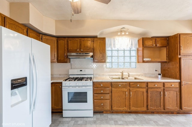 10624 S Ave H Rd, Chicago, IL 60617 - kitchen featuring white appliances, a sink, under cabinet range hood, and brown cabinetry
