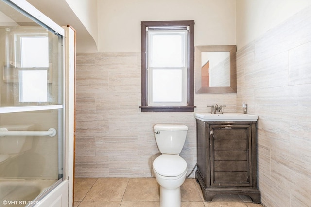 10624 S Ave H Rd, Chicago, IL 60617 - full bath with tile walls, toilet, vanity, tile patterned floors, and bathtub / shower combination