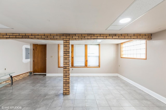 10624 S Ave H Rd, Chicago, IL 60617 - unfurnished room featuring electric panel, light tile patterned floors, baseboards, and arched walkways