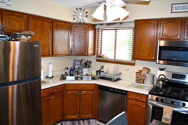 17429 W Chestnut Ln, Gurnee, IL 60031 - kitchen featuring appliances with stainless steel finishes, light countertops, a ceiling fan, and brown cabinetry