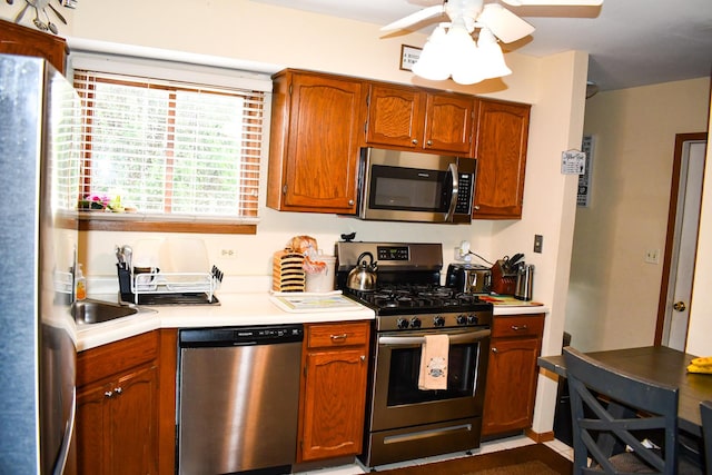 17429 W Chestnut Ln, Gurnee, IL 60031 - kitchen featuring appliances with stainless steel finishes, light countertops, a ceiling fan, and brown cabinets